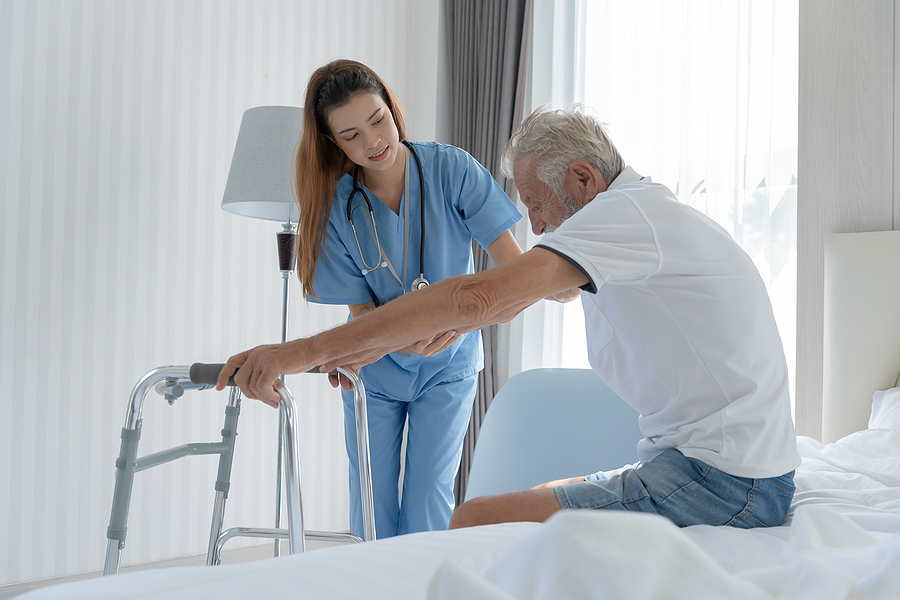 nurse-helping-elderly-man-walker.jpg